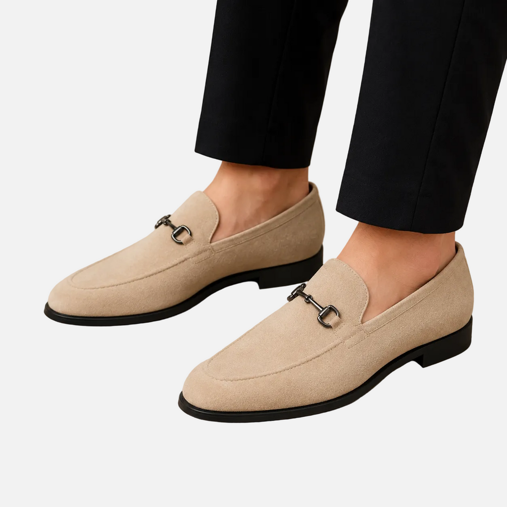 Beige loafers with a metallic buckle on a white background
