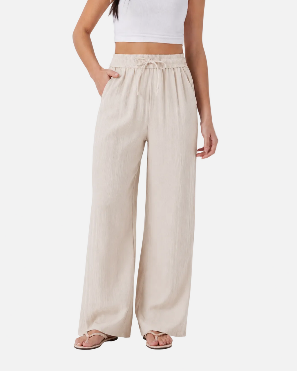 Beige wide-leg pants worn by a person on a white background