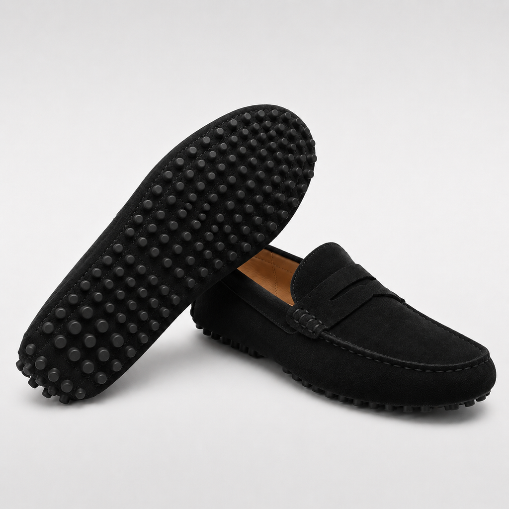 Black loafers with textured sole on a light gray background