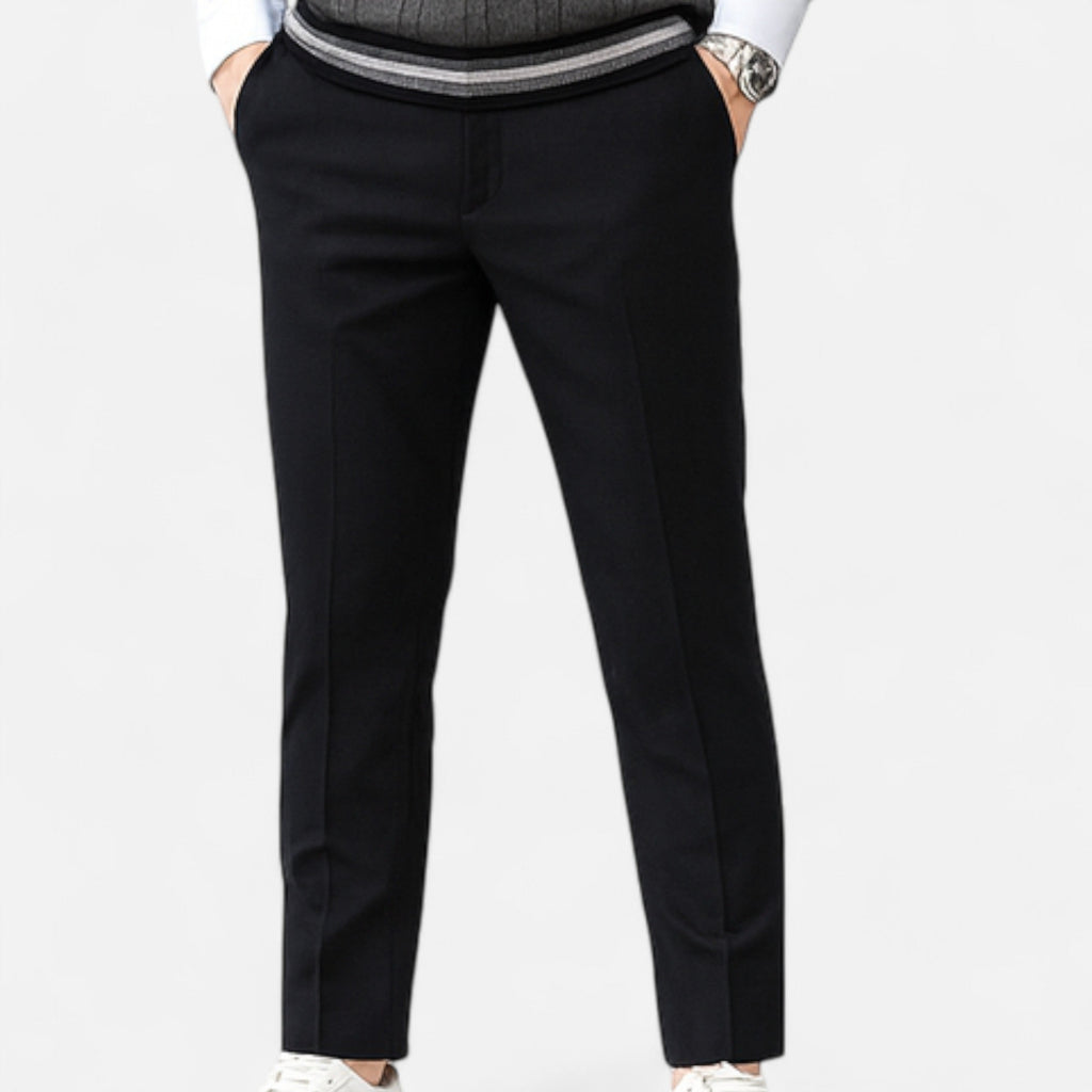 Black pants worn by a person on a white background