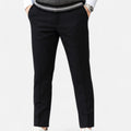 Black pants worn by a person on a white background