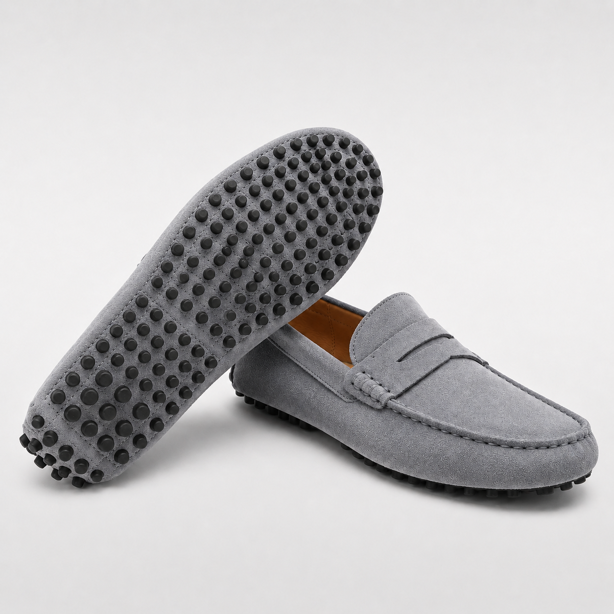 Gray loafers with textured sole on a light gray background