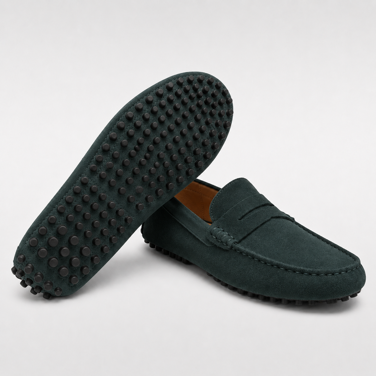 Green loafers with textured sole on a light gray background