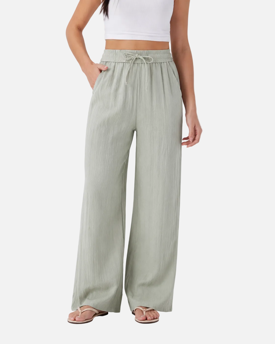 Light green wide-leg pants worn by a person on a white background