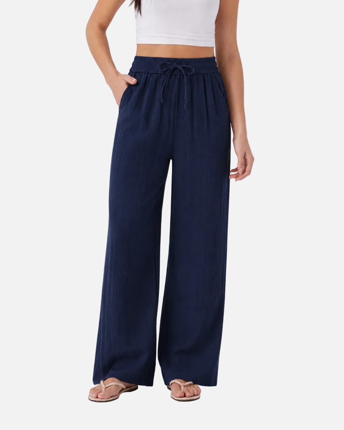 Navy wide-leg pants worn by a person on a light gray background