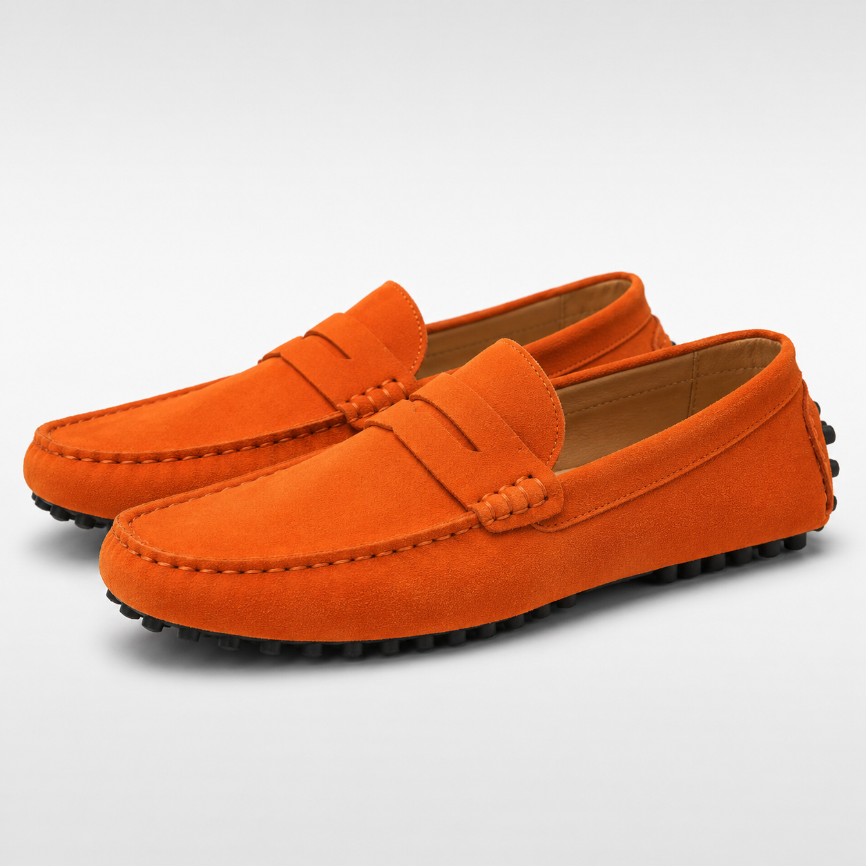 Orange loafers on a light gray background