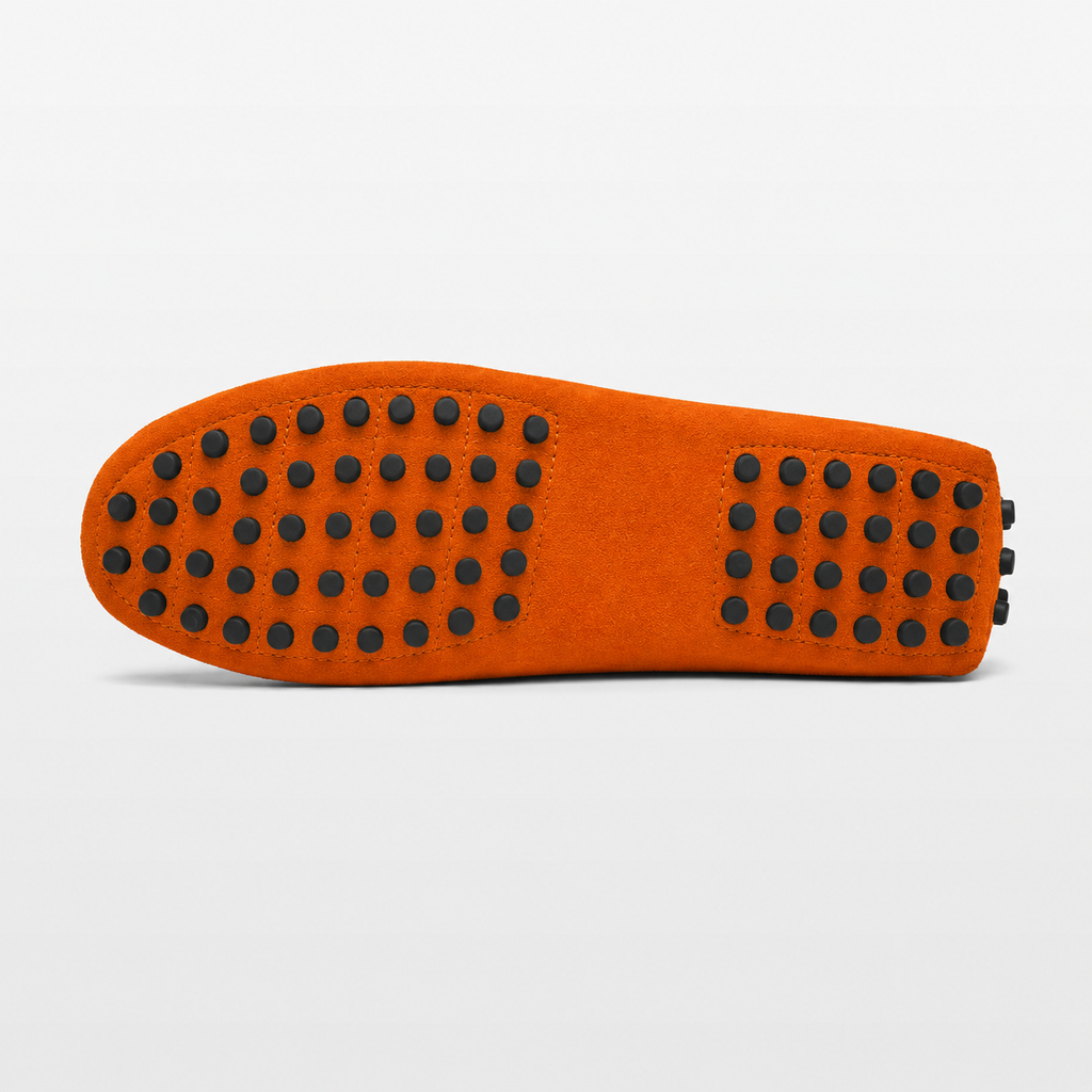 Orange shoe sole with black textured pattern on a light gray background