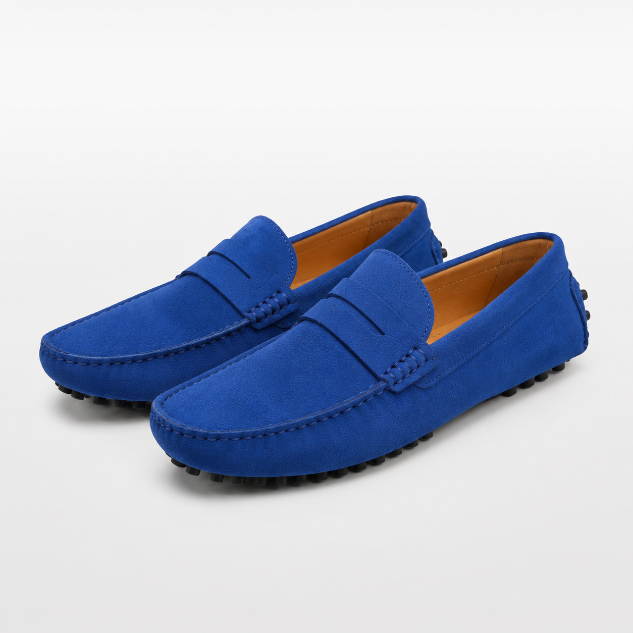 Pair of blue loafers on a light gray background