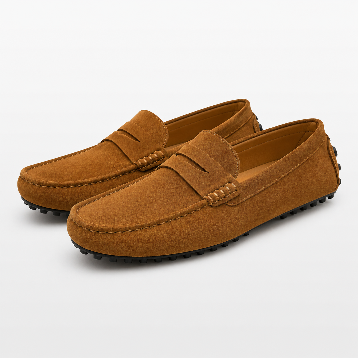 Pair of brown suede loafers on a light gray background