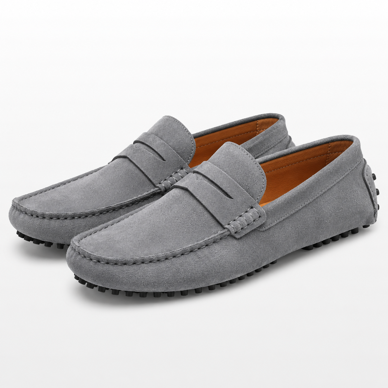 Pair of gray suede loafers on a white background