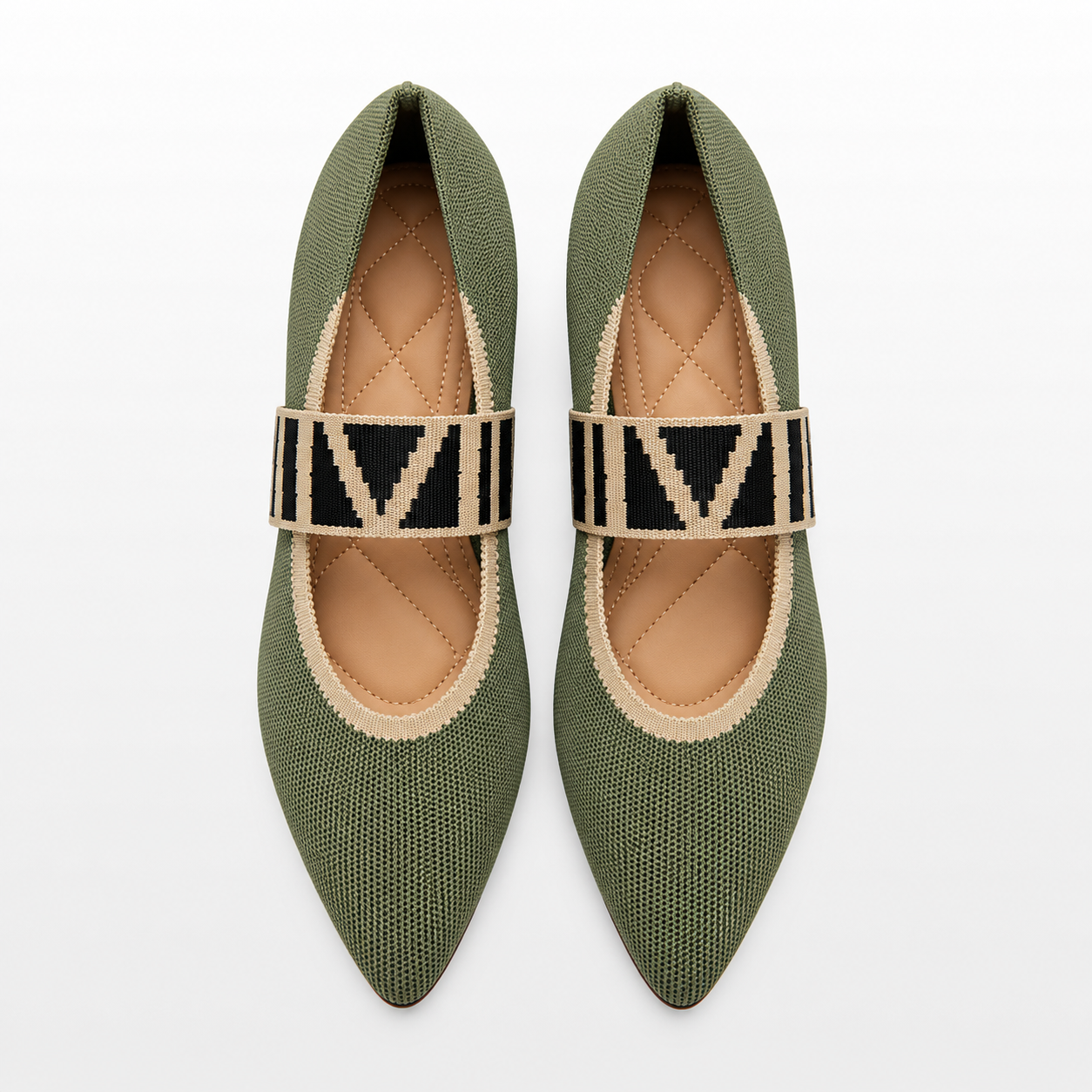 Pair of green pointed-toe flats with patterned straps on a white background