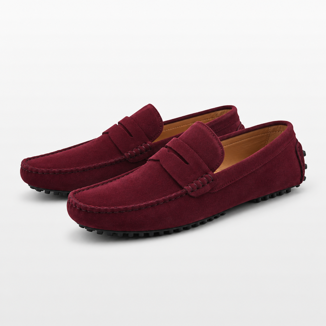 Pair of maroon loafers on a light gray background