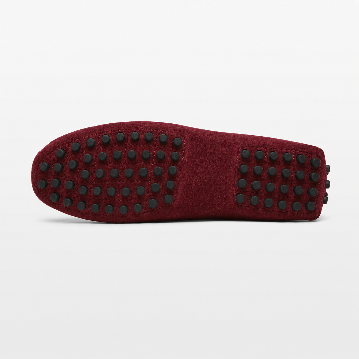 Red slipper with black textured sole on a white background