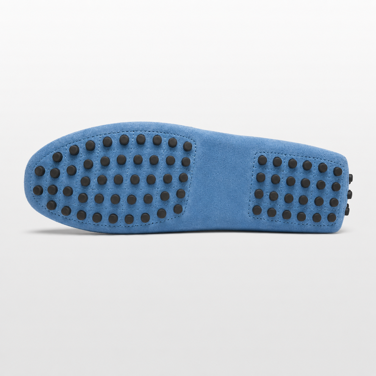 Blue shoe sole with black textured pattern on a light gray background