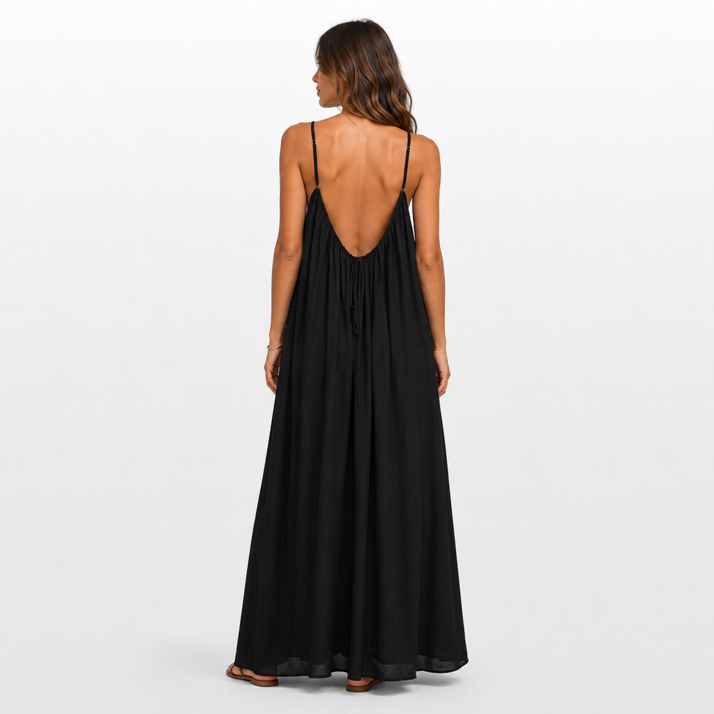 Woman wearing a black dress with an open back on a white background