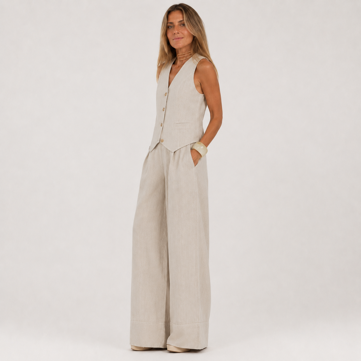 Woman wearing a beige jumpsuit on a white background