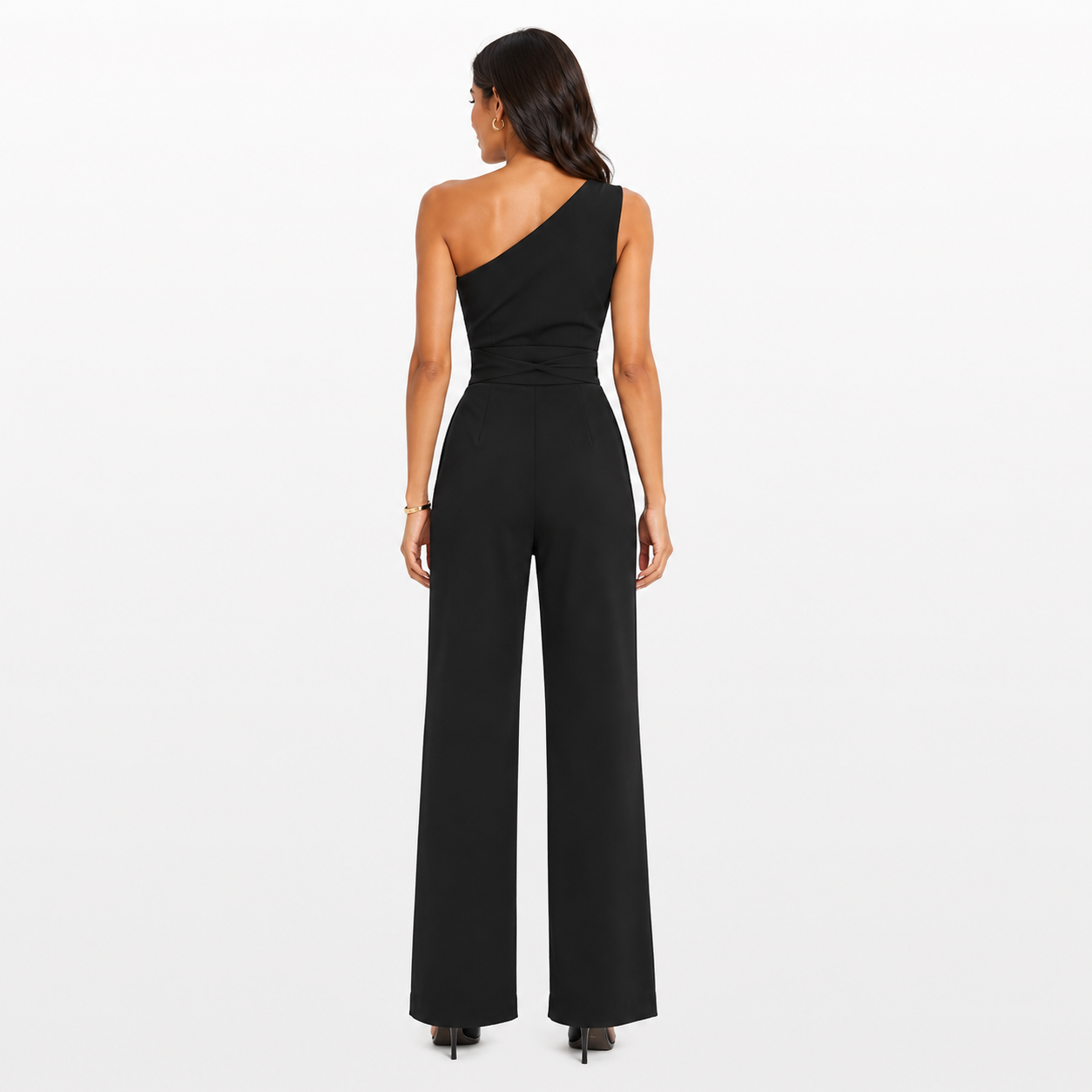 Woman wearing a black one-shoulder jumpsuit on a white background