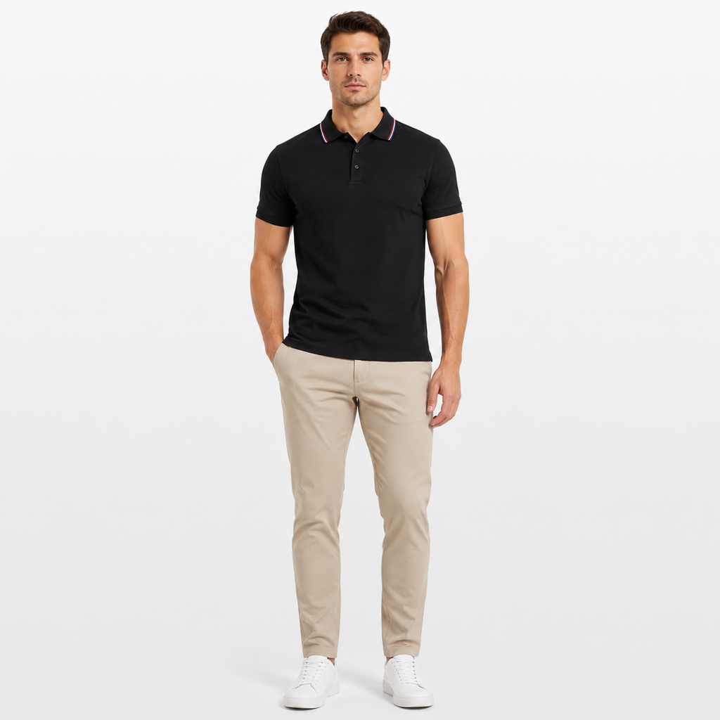 Man wearing a black polo shirt and beige pants on a white background
