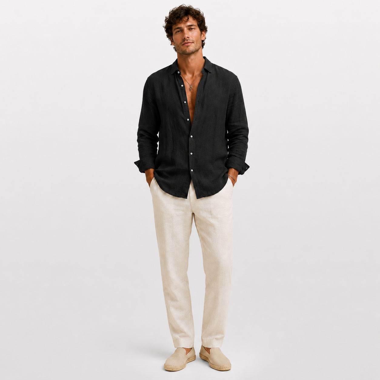 Man wearing a black shirt and beige pants on a white background