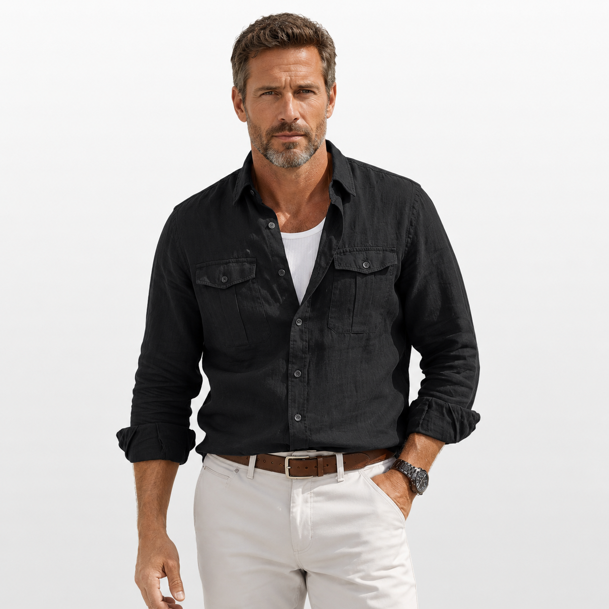 Man wearing a black shirt and white pants on a light gray background