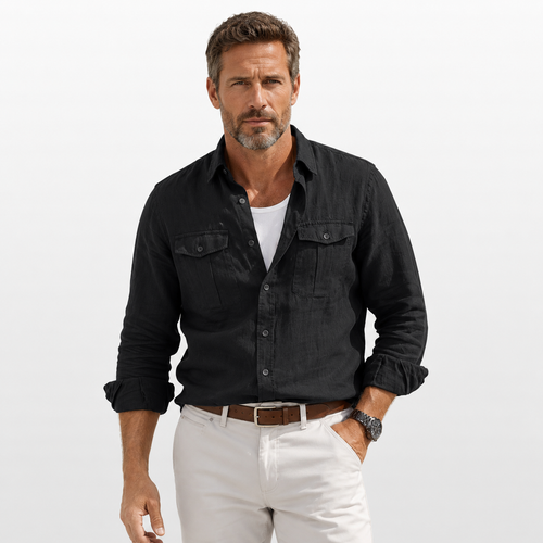 Man wearing a black shirt and white pants on a light gray background