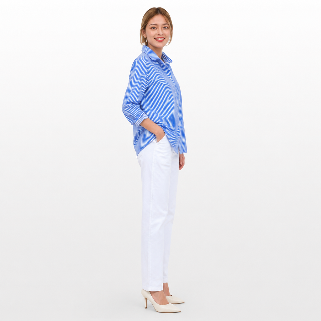Woman wearing a blue striped shirt and white pants on a white background