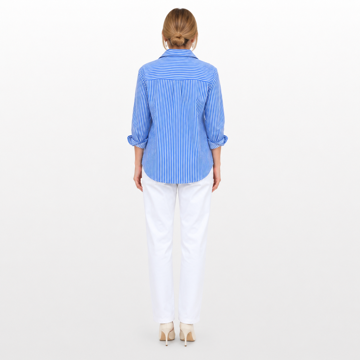Woman wearing a blue striped shirt and white pants on a white background