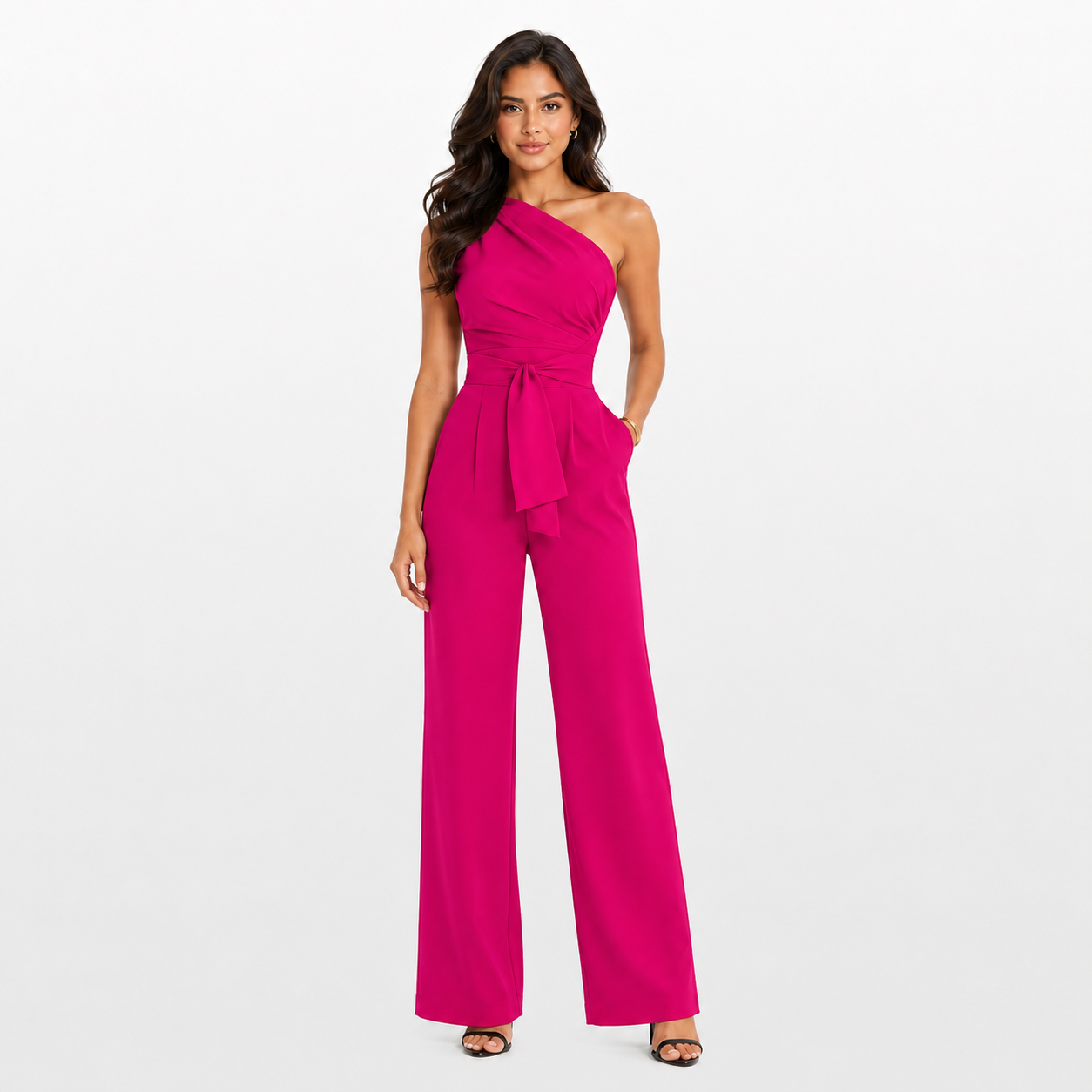 Woman wearing a bright pink one-shoulder jumpsuit on a white background