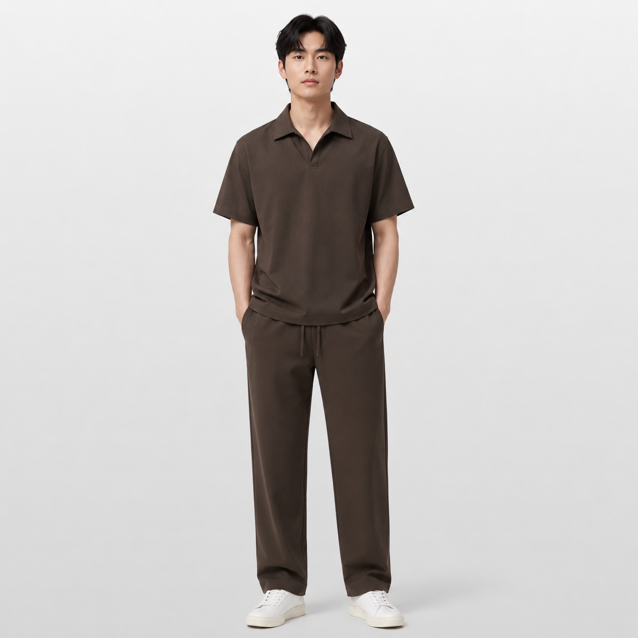Man wearing a brown polo shirt and pants on a white background