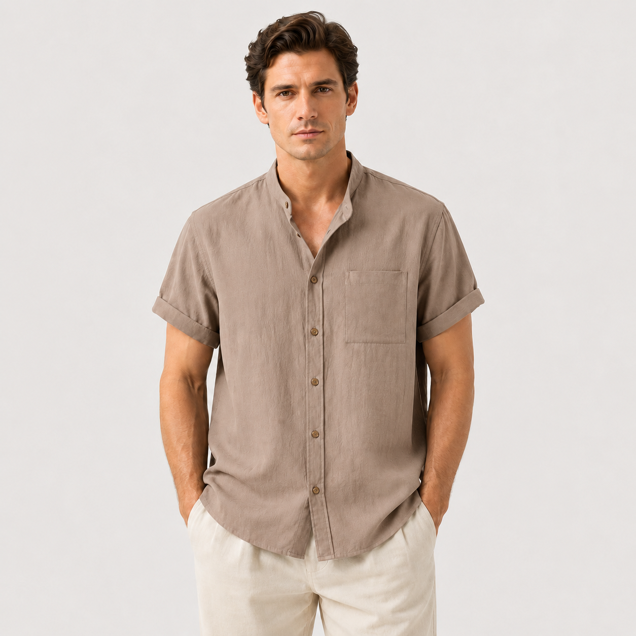 Man wearing a brown short-sleeve shirt with a neutral background