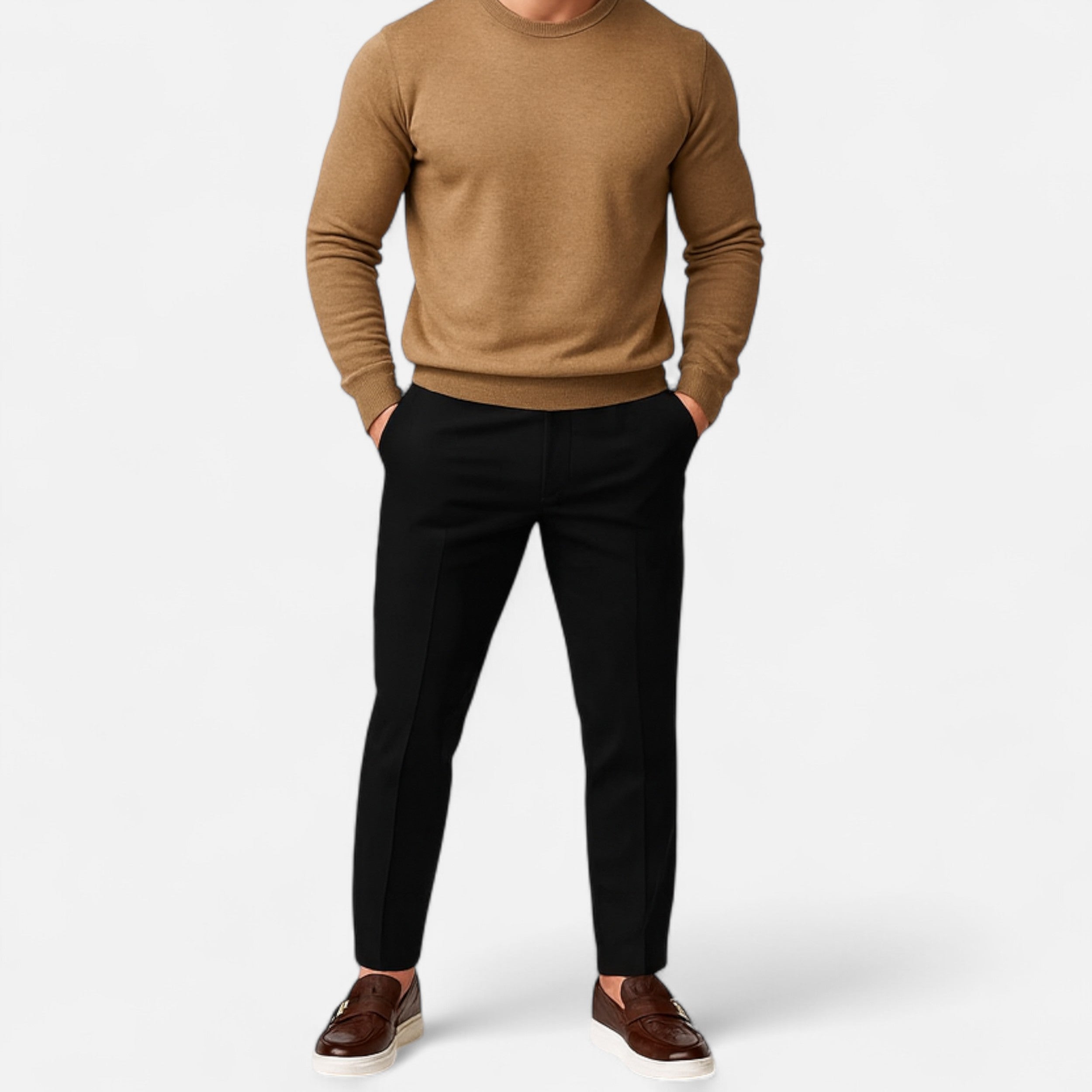 Person wearing a brown sweater and black pants on a white background