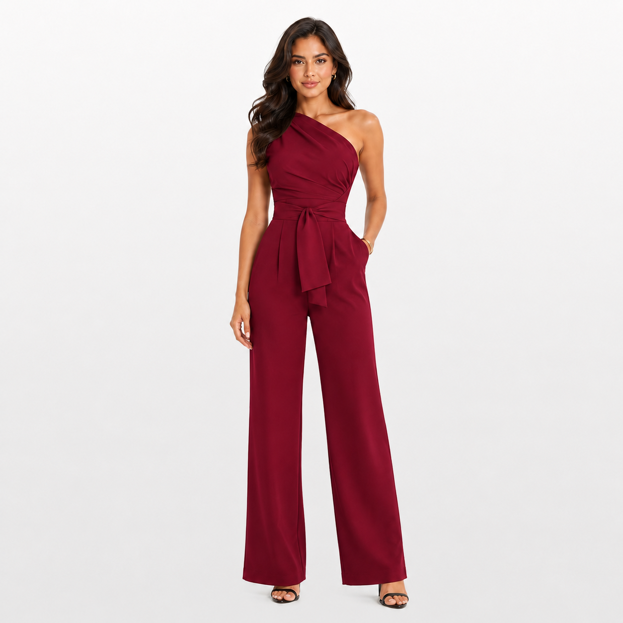 Woman wearing a burgundy one-shoulder jumpsuit on a white background