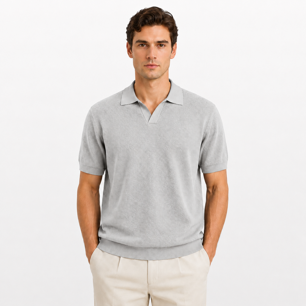 Man wearing a gray polo shirt and beige pants on a white background