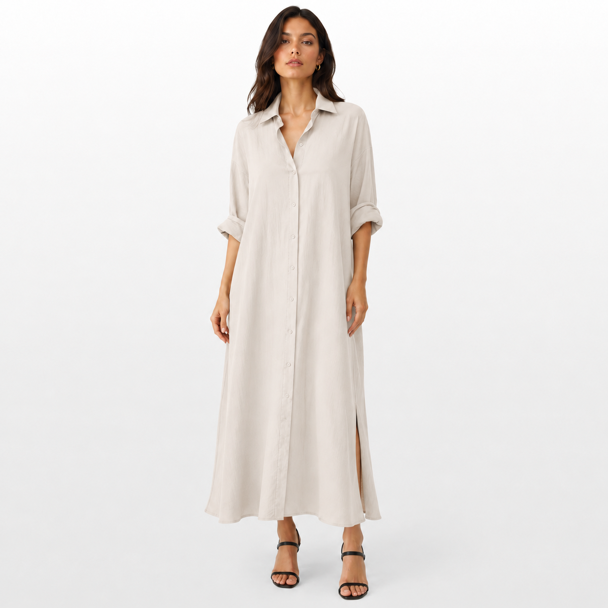 Woman wearing a long beige dress on a white background