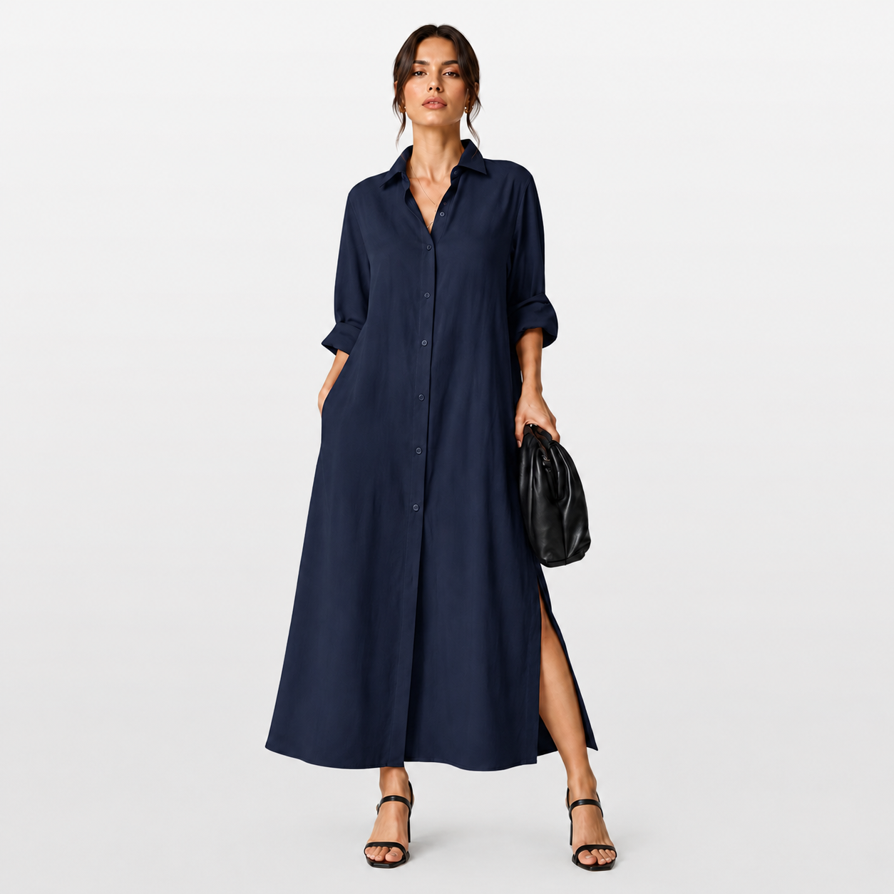 Woman wearing a long navy dress on a light gray background