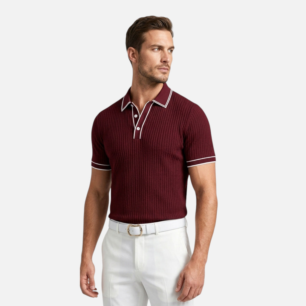 Man wearing a maroon polo shirt with white trim on a light gray background