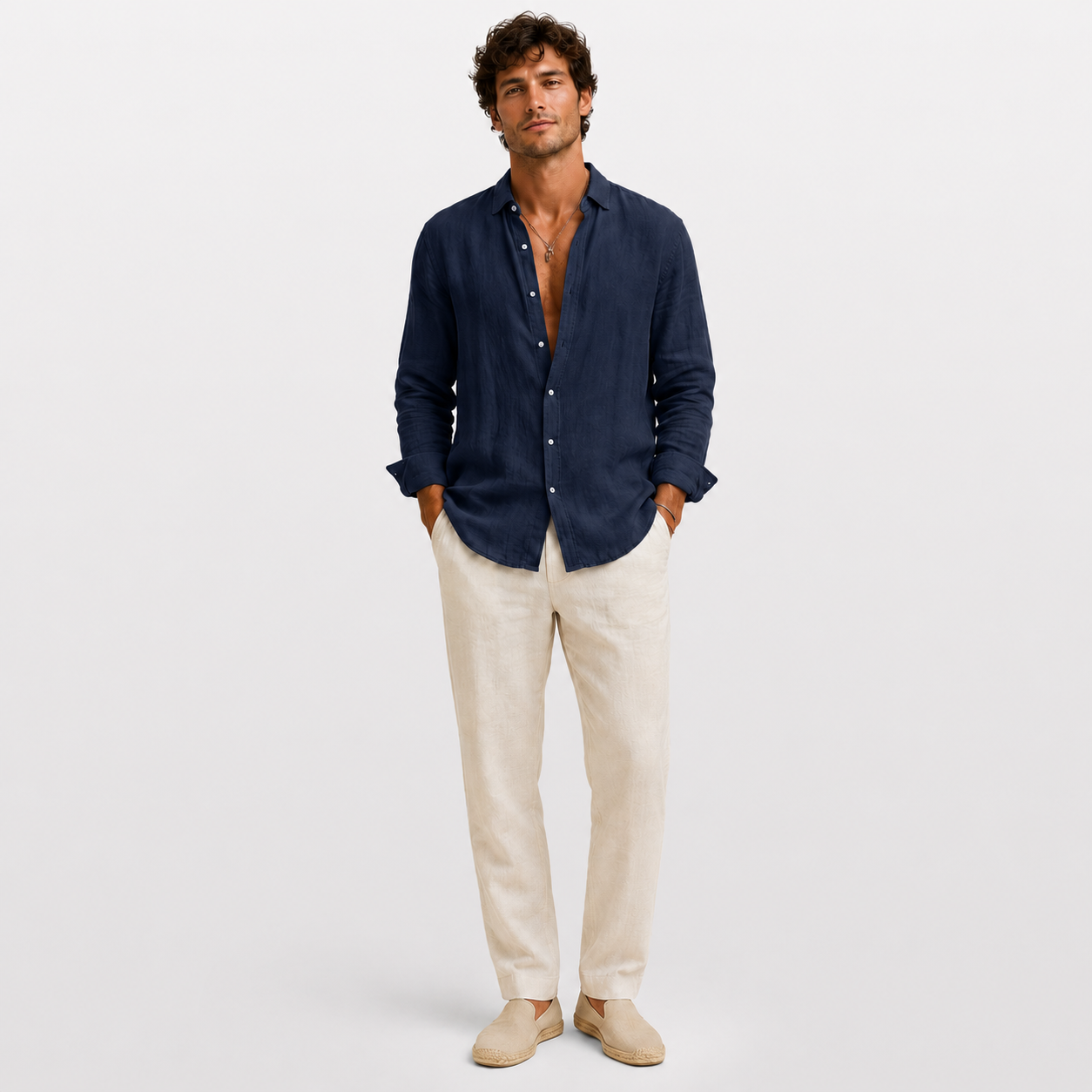 Man wearing a navy shirt and beige pants on a white background