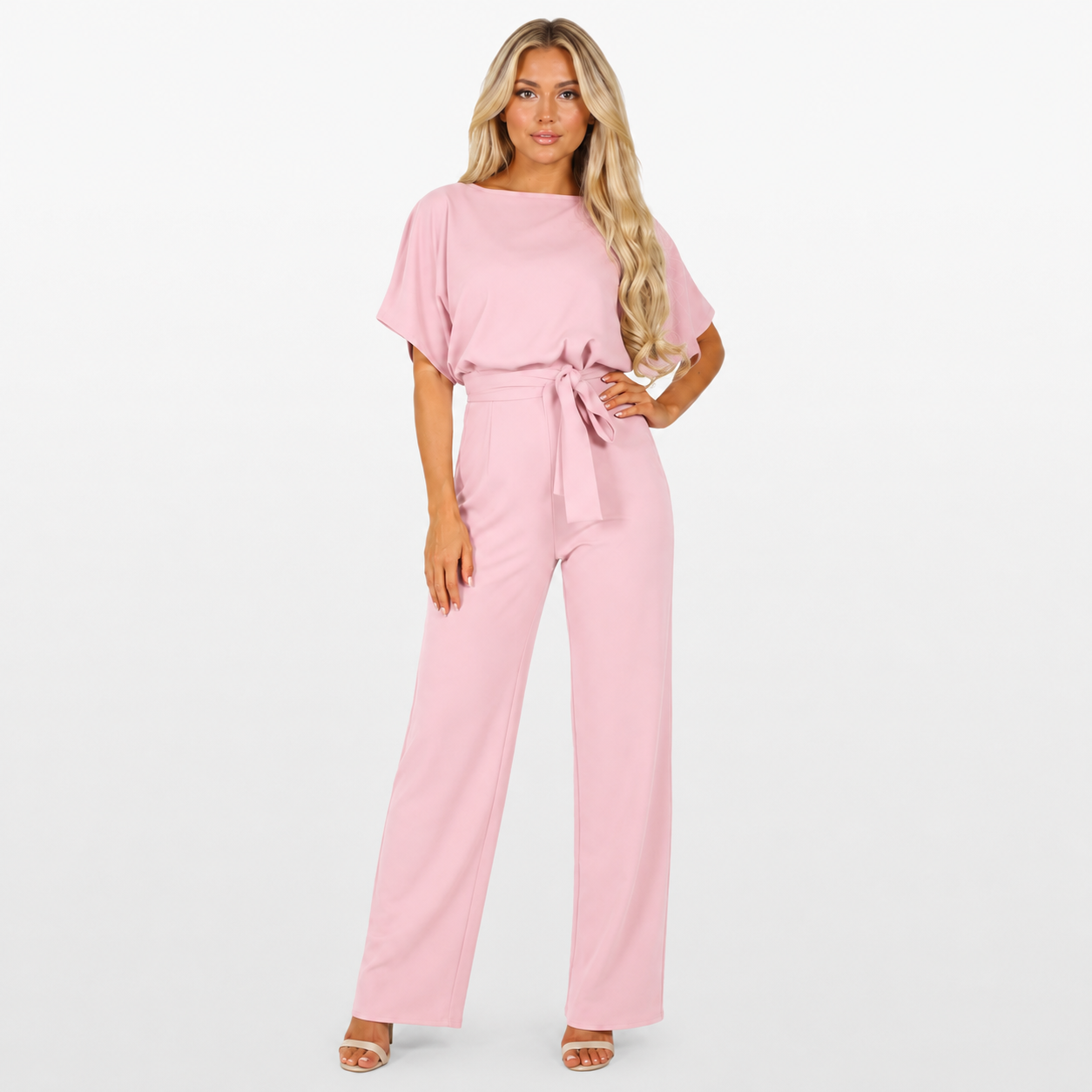 Woman wearing a pink jumpsuit on a white background