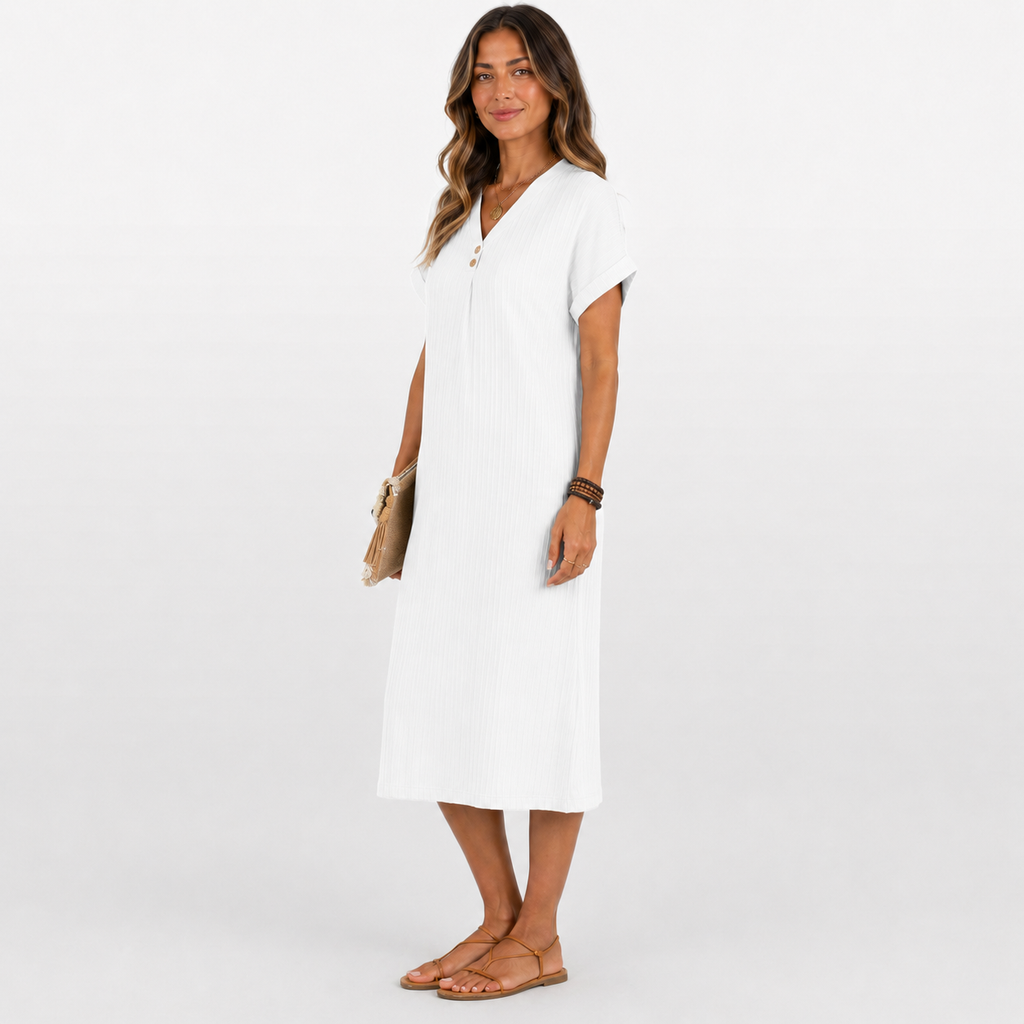 Woman wearing a white dress on a plain background