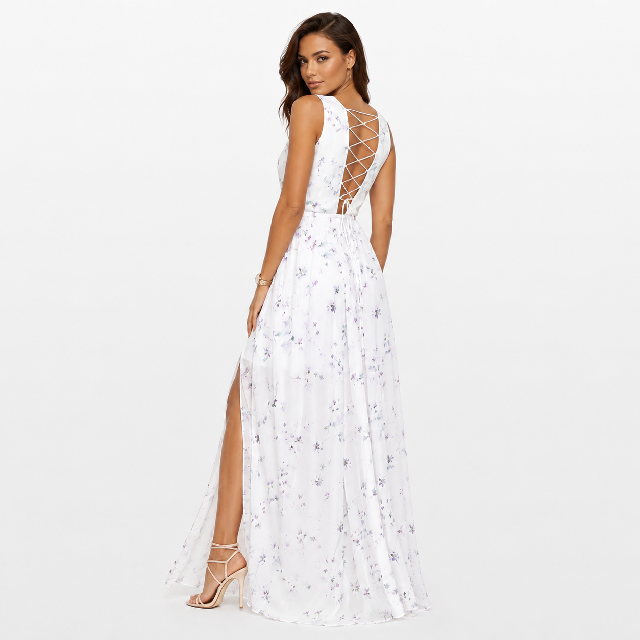 Woman wearing a white floral dress with lace-up back on a white background