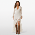 Woman wearing a white lace dress with fringe and brown boots on a white background