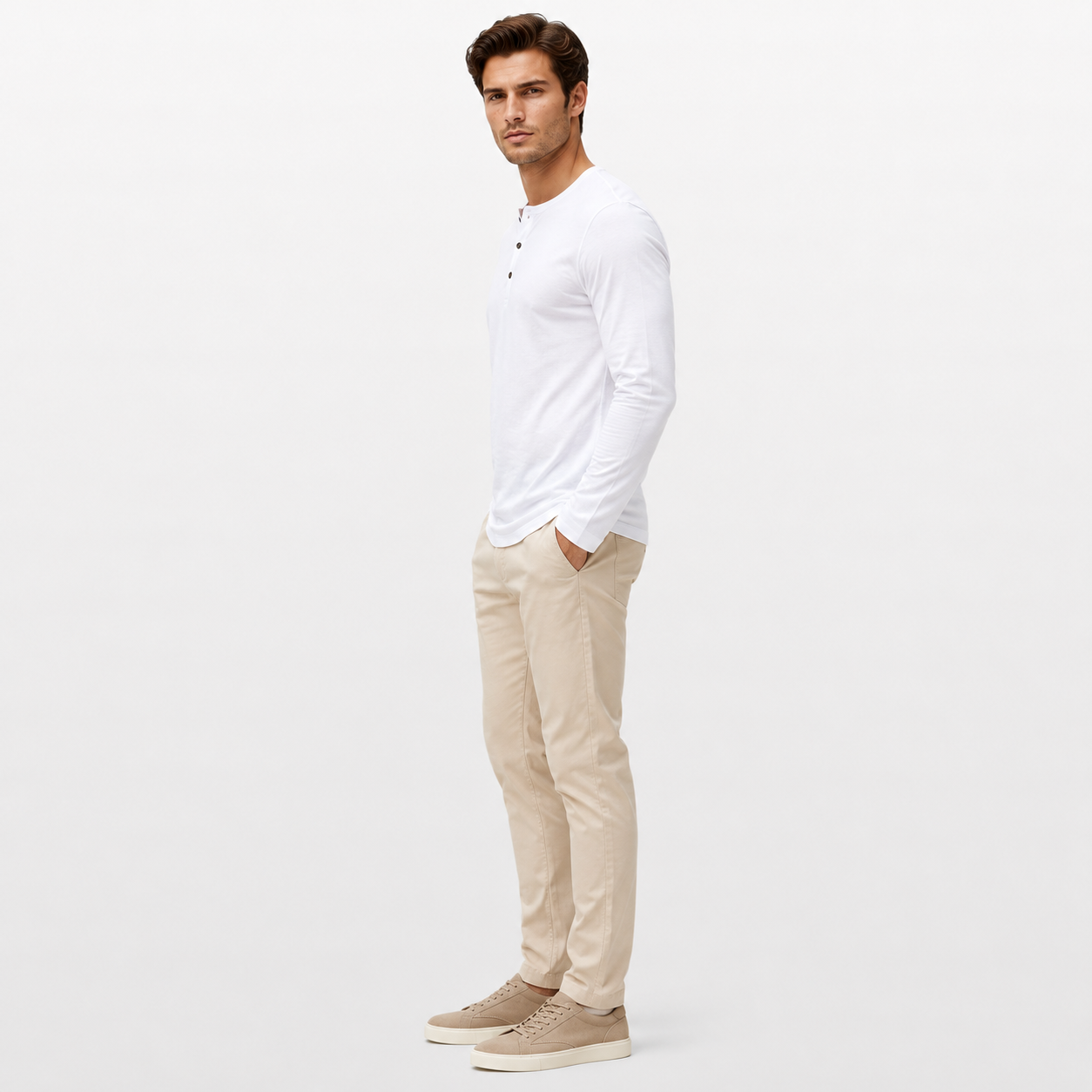 Man wearing a white long-sleeve shirt and beige pants on a white background