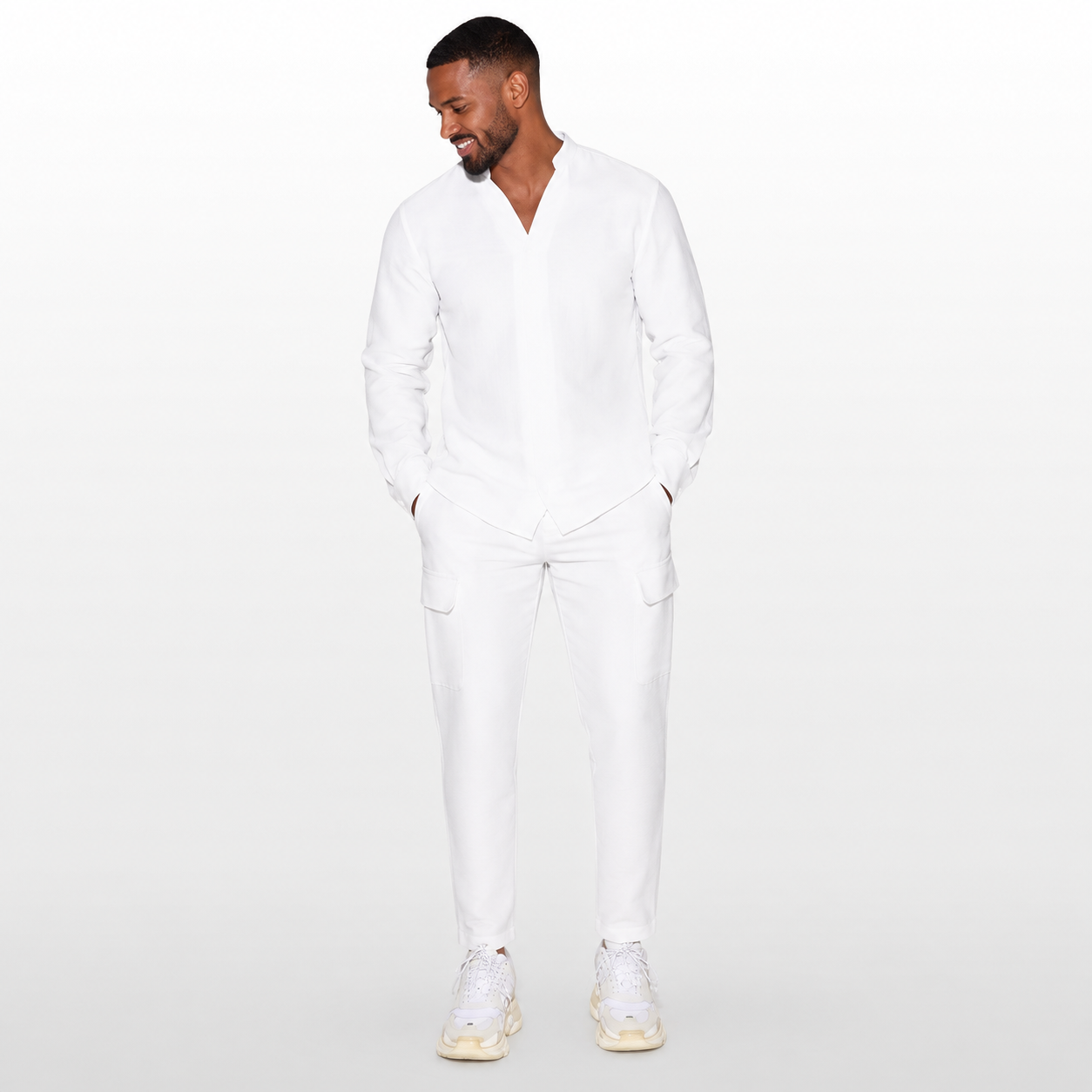 Man wearing a white outfit on a plain background