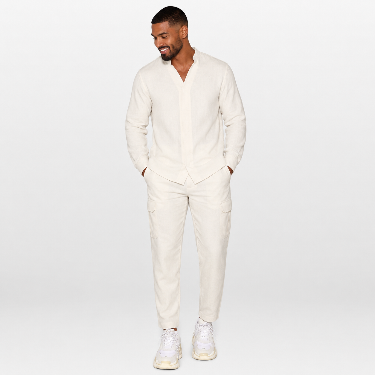 Man wearing a white outfit with a plain background
