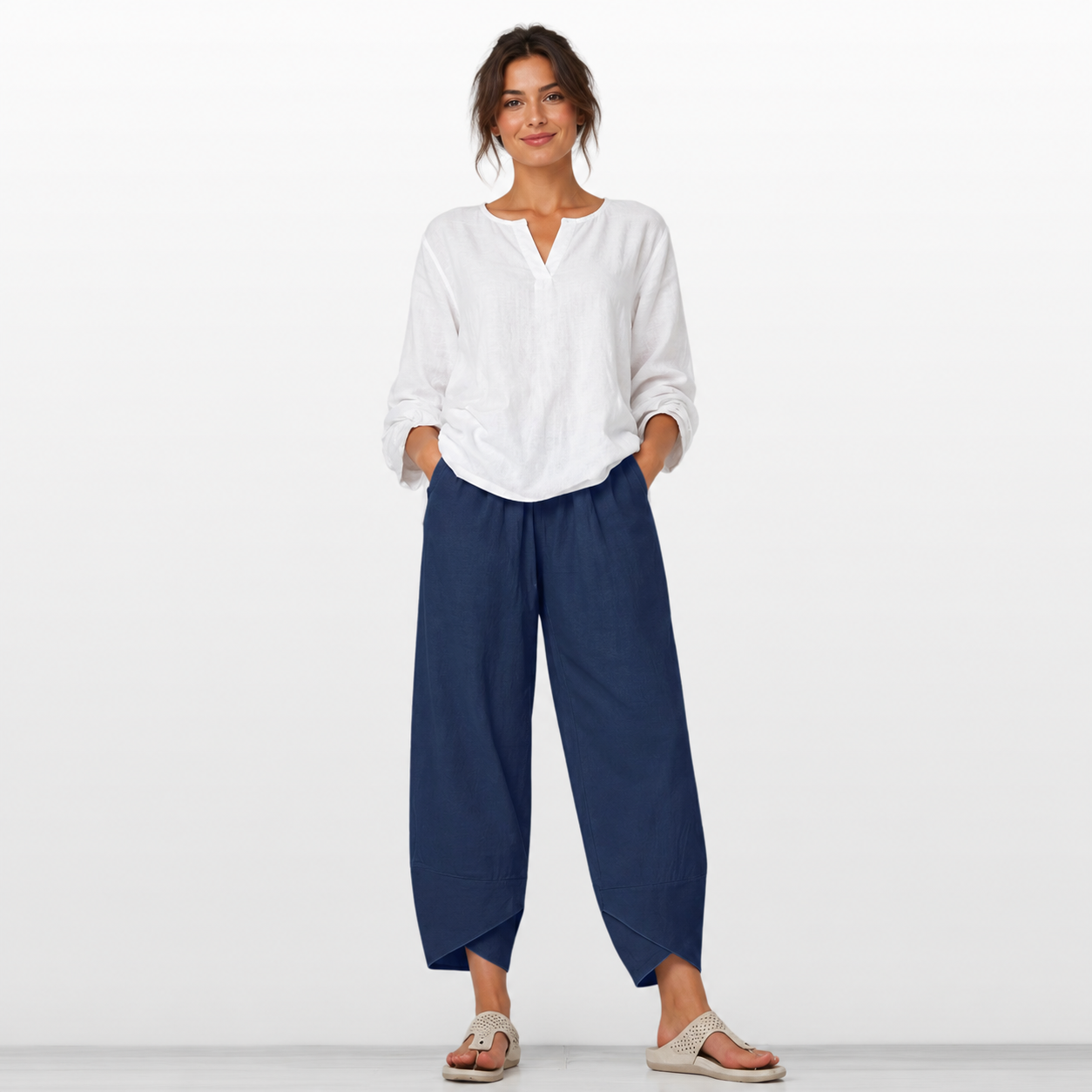 Woman wearing a white shirt and blue pants on a white background