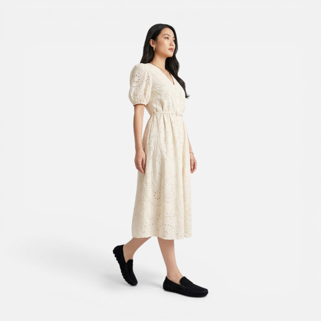 Woman wearing a beige dress on a white background