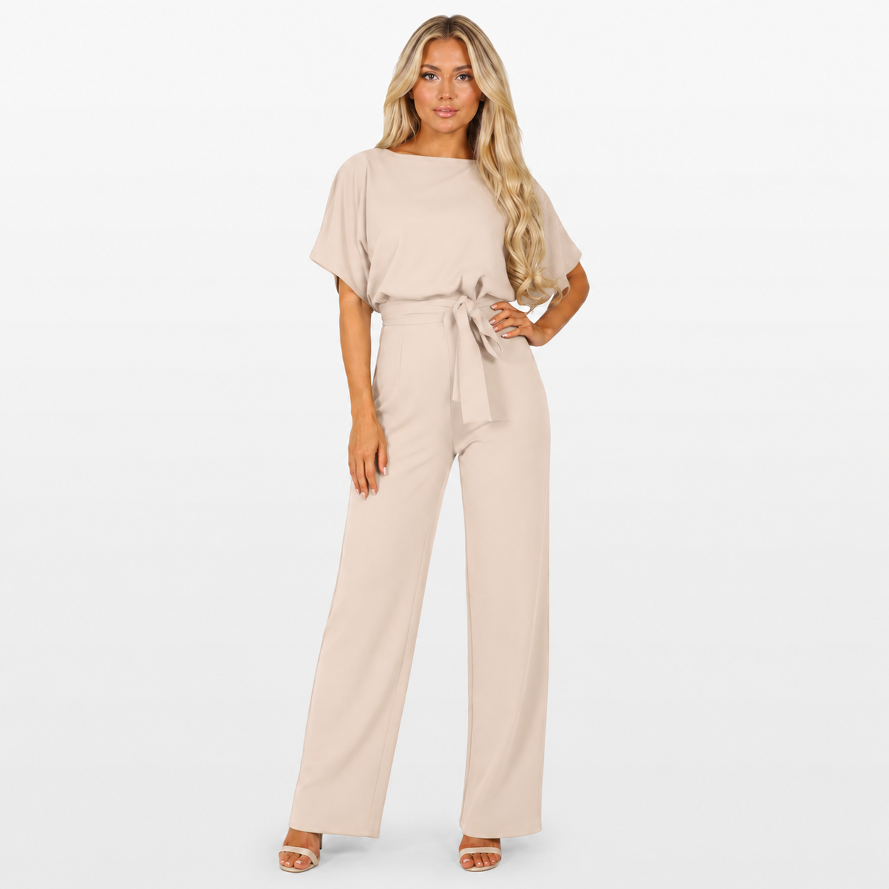 Woman wearing a beige jumpsuit on a white background