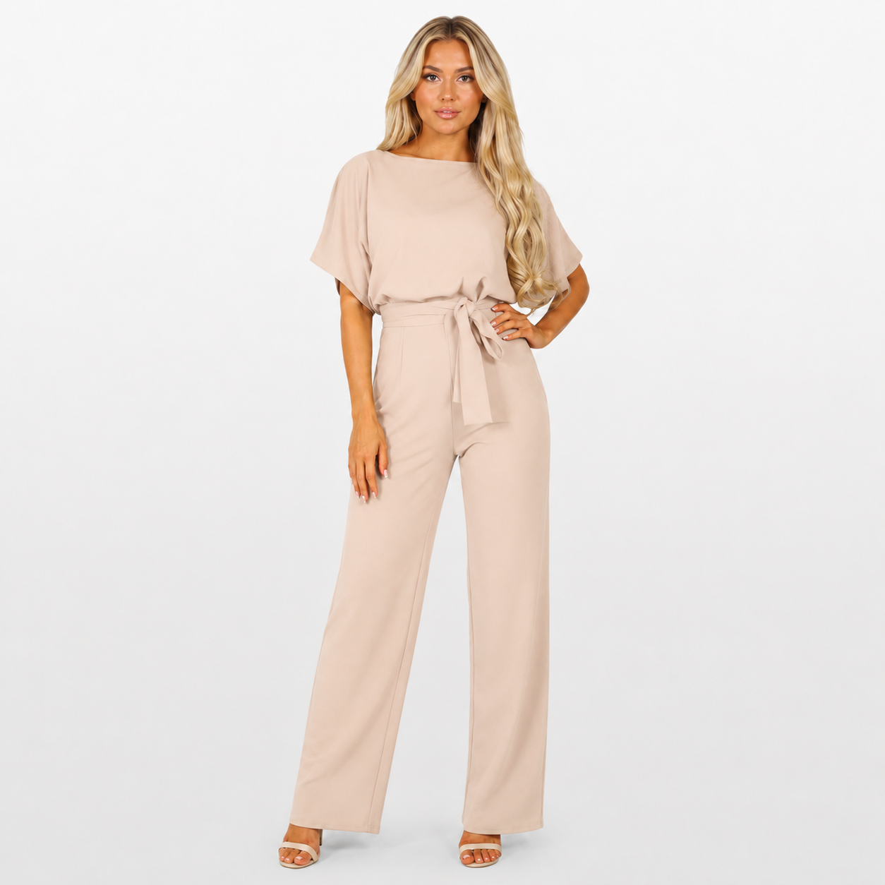 Woman wearing a beige jumpsuit on a white background