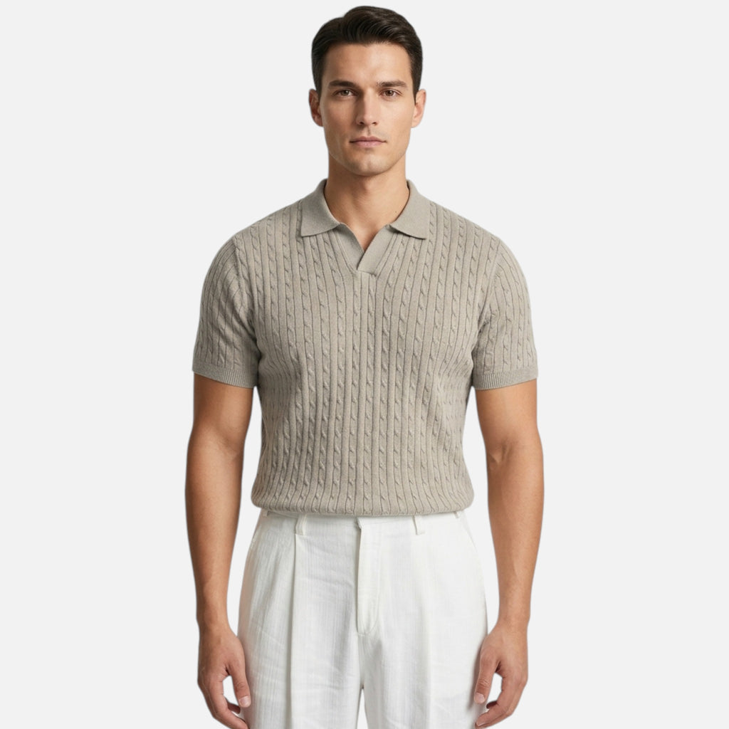 Man wearing a beige knitted polo shirt and white pants on a white background
