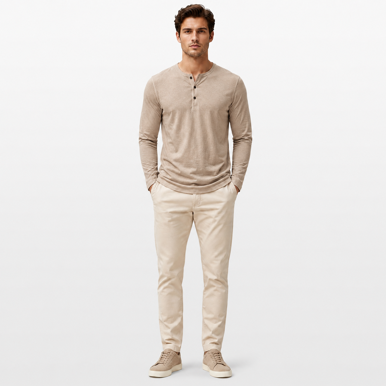 Man wearing a beige long-sleeve henley shirt and pants on a white background